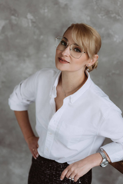Beautiful middle aged business woman in glasses standing over isolated white background with a happy and cool smile on her face. Happy man. Soft selective focus. - Foto, Bild