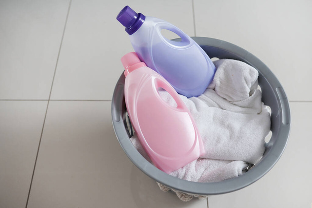 Fabric softener for those laundry days when youre feeling extra. High angle shot of a washing basket filled with clean laundry and two bottles of fabric softener - Fotografie, Obrázek