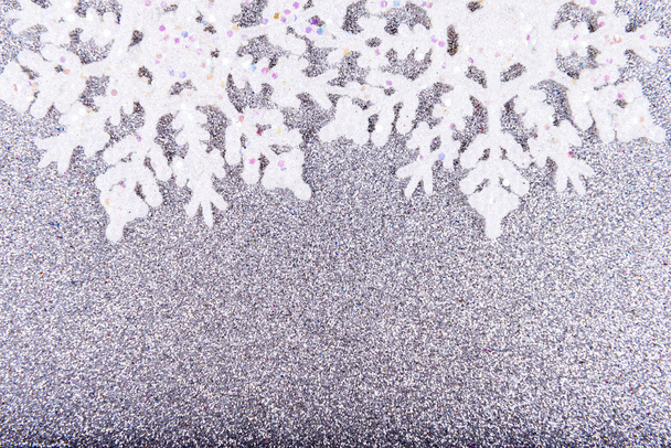 Flocons de neige blancs sur fond de paillettes argentées
 - Photo, image