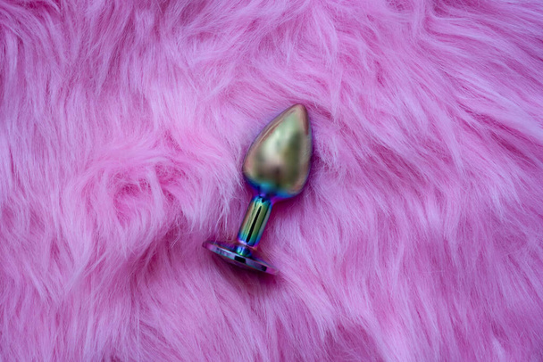 anal butt plug sex toy on fur pink background, sex shop advertisement - Foto, afbeelding