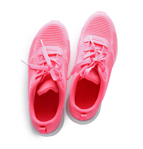 Pair of stylish pink sneakers on white background, top view - Фото, изображение