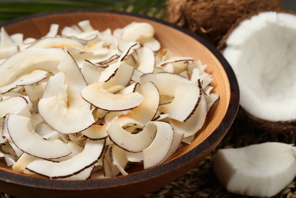 Tasty coconut chips in wooden bowl, closeup - Zdjęcie, obraz