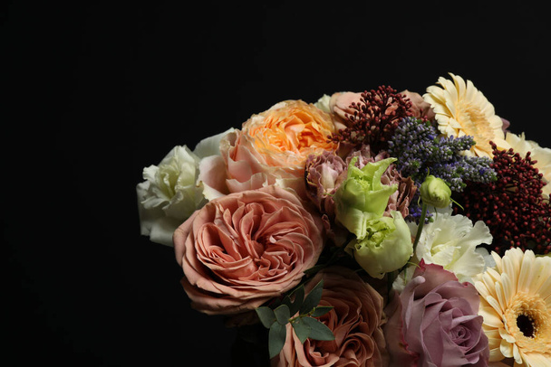 Bouquet of beautiful flowers on black background - Фото, изображение