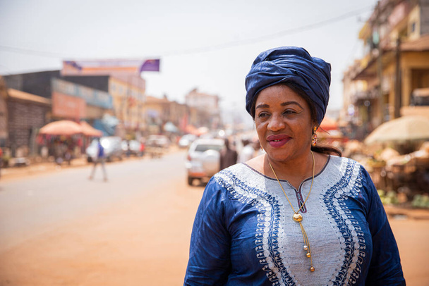 Portrait of a beautiful mature african lady in the city center in africa. - Fotó, kép