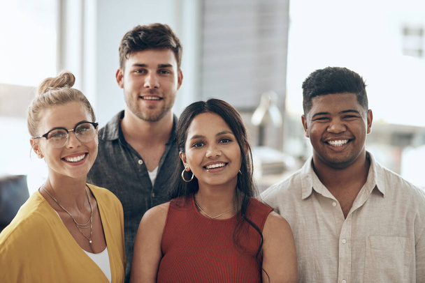 Success thrives in a company filled with dedicated employees. Portrait of a group of businesspeople standing together in an office - Foto, imagen
