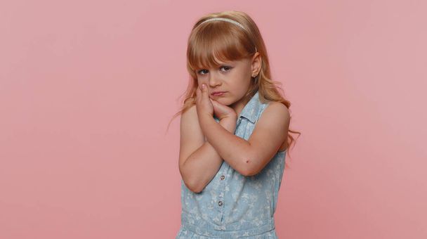 Dental problems. Young preteen child girl kid touching cheek, closing eyes with expression of terrible suffer from painful toothache, sensitive teeth, cavities. Toddler children on pink background - Foto, Imagen