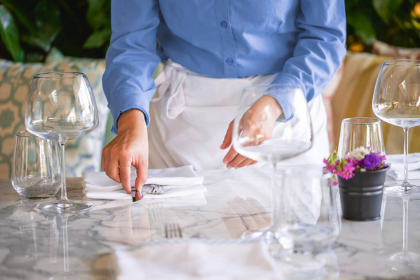 Waitress serving the empty table of the luxury restaurant - Photo, image