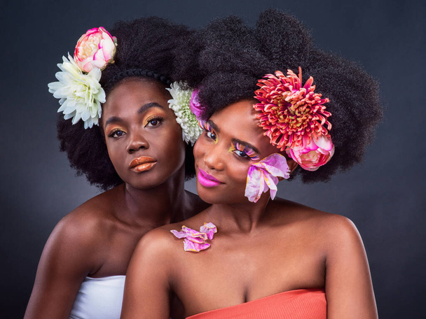 I hope you blossom like the flower you are. two beautiful women posing together with flowers in their hair - Fotografie, Obrázek