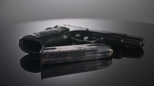 9mm gun rotating on a reflective surface - Video, Çekim