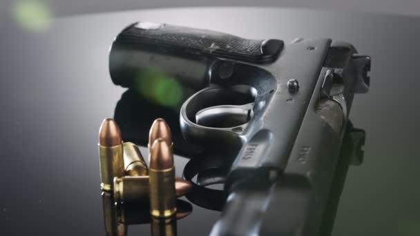 9mm gun rotating on a reflective surface - Felvétel, videó