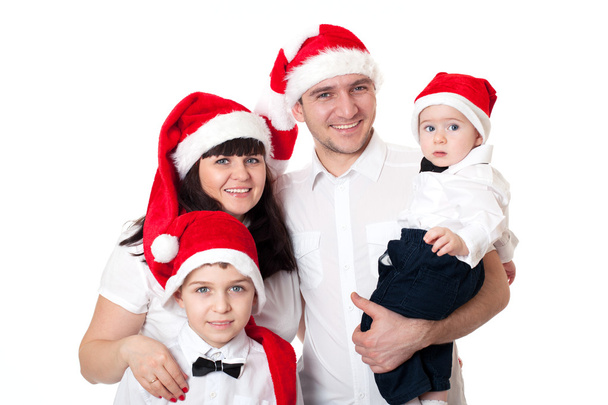 Happy cute family in santa's hats - 写真・画像