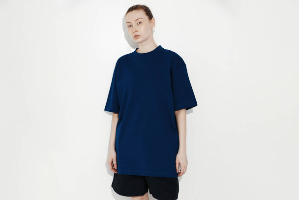 female dark blue t-shirt mockup on girl, isolated on white background, copy space - Photo, Image