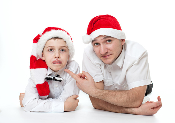 father and son in Santa's hats - Foto, imagen