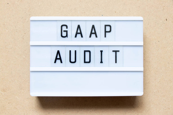 Lightbox with word GAAP (Abbreviation of Generally accepted accounting principles) audit on wood background - Zdjęcie, obraz
