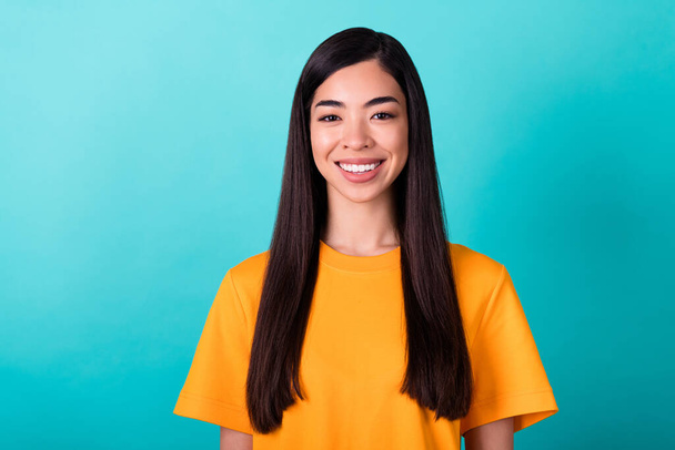 Photo of girlish cheerful nice woman straight hairdo wear yellow t-shirt smiling look at camera isolated on turquoise color background. - Fotografie, Obrázek