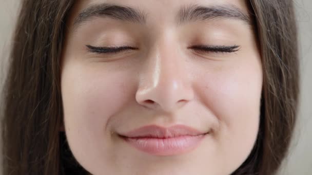 Close up human young female face sensual 20s generation arabian girl beautiful model glamour lady with closed eyes opening eyelids enjoying good eyesight in dark lenses after ophthalmology procedure - Filmmaterial, Video