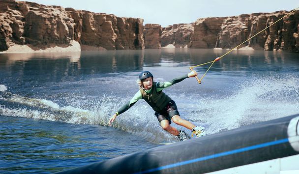 Wakeboarder making tricks on the river. Wakeboarding. Water spor - Photo, Image
