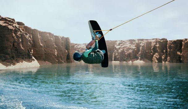 Wakeboarder making tricks on the river. Wakeboarding. Water spor - 写真・画像