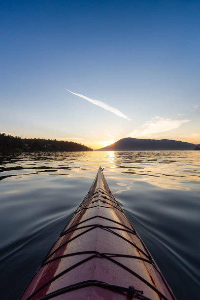 Sea Kayak paddling in the Pacific Ocean. Colorful Sunset Sky. Taken near Victoria, Vancouver Islands, British Columbia, Canada. Concept: Sport, Adventure - Fotoğraf, Görsel