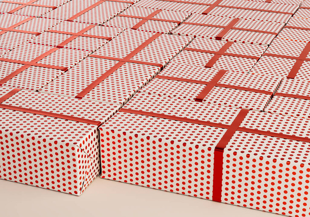 A collection of different sized rectangular gift boxes wrapped in polka dot red gift wrap paper with a red ribbon laid out flat on an isolated studio background - 3D render - Fotografie, Obrázek