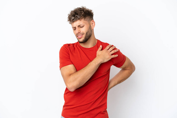 Young caucasian handsome man isolated on white background suffering from pain in shoulder for having made an effort - Foto, afbeelding