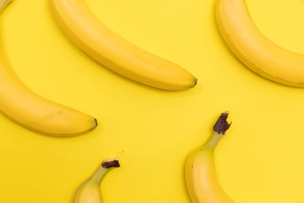 Group of bananas shot on a yellow background - Foto, Imagem