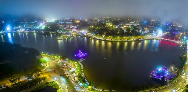 Aerial view of Da Lat city night beautiful tourism destination in central highlands Vietnam. Urban development texture, green parks and city lake. - 写真・画像