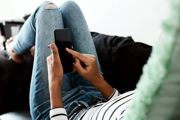And send... a woman using a smartphone on the sofa at home - Φωτογραφία, εικόνα