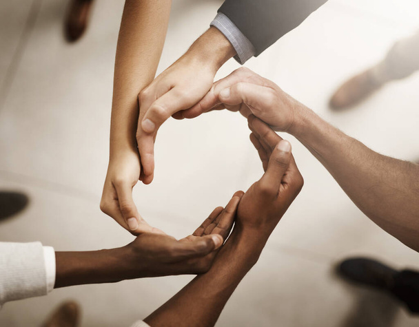Group of businesspeople joining their hands in solidarity in the workplace. Professional business people in unity for equality, diversity and success in a diverse teamwork - Foto, imagen