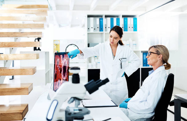 Clinical research helps translate medical discoveries into working treatments. two scientists working together on a computer in a lab - 写真・画像