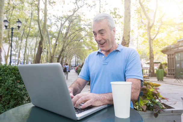 Senior Man with Computer at Park - Фото, изображение