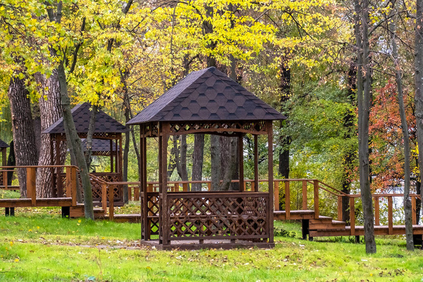 Empty wooden gazebos in a city park on an autumn day no people - Photo, image