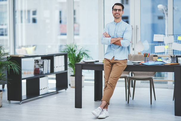 Hes a true leader and achiever. Portrait of a young designer standing in an office - Zdjęcie, obraz