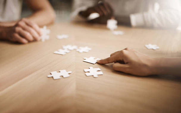 Business people brainstorming solution, problem solving and showing teamwork, working together on puzzle pieces. Team or smart business group activity for unity workflow in difficult corporate crisis. - Photo, Image