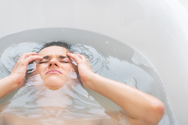 Stressed young woman laying in bathtub - Foto, immagini