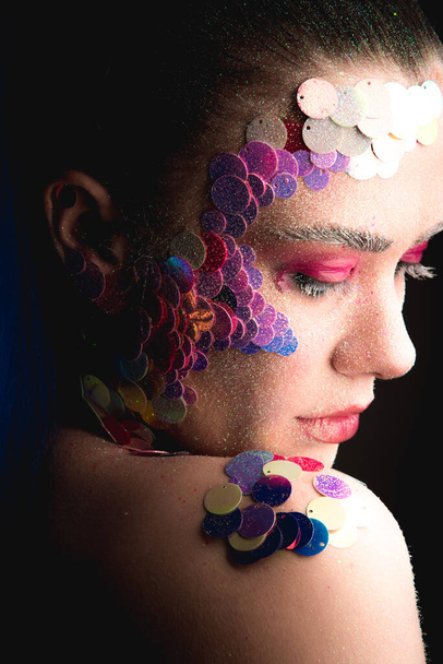 Creative sandy face makeup of a girl with colorful sequins - Zdjęcie, obraz