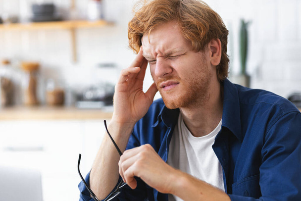 Close up portrait of tired stressed Caucasian man having headache feeling sick, pain, depression, overwork concept - Photo, Image