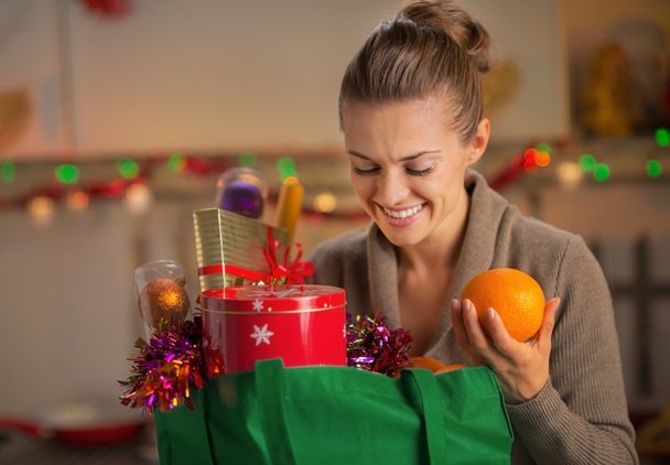 Young housewife with christmas shopping bag in christmas decorat - Fotografie, Obrázek