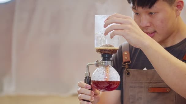 Professional baristas making coffee like a Siphon Coffee Maker. 4k Slow Motion video  (The submitted footage is a grouping shooting arrangement) - Materiał filmowy, wideo