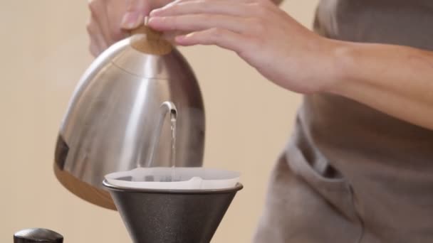 Профессиональный бариста проливает воду на кофейные гущи в фильтре как ручной процесс. CU Shot, 4k Slow Motion video) - Кадры, видео