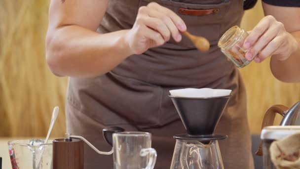 A professional barista pours water over the coffee grounds in the filter as a manual process. CU Shot, 4k Slow Motion video (The submitted footage is a grouping shooting arrangement) - Filmmaterial, Video