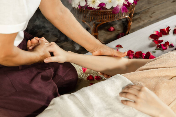 Asian woman enjoying a salt scrub massage at spa. Healthcare spa - Foto, imagen