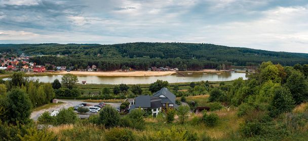 Panoramic view from the observation tower on the reservoir in Krasnobrd. Hills covered with forest. Beach by the lagoon. Krasnobrod, Poland - Photo, image