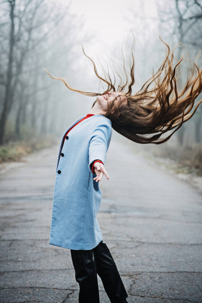 Stress resilience. Spend Time in Nature to Reduce Stress and Anxiety. Nature break relieves stress. Alone Young woman with long fluttering hair express emotions in forest - Foto, Imagen