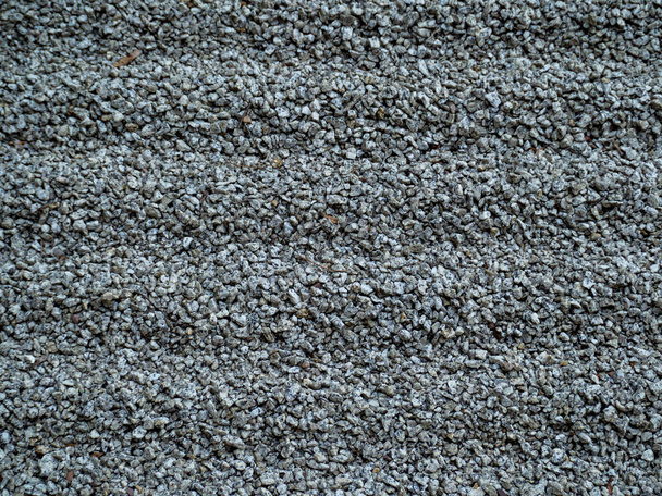 Small rubble. Background of gray rubble. Close up. Coarse gray sand. - Fotó, kép