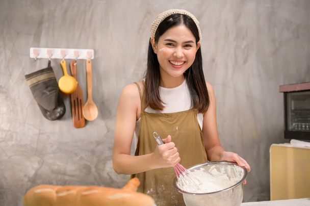 A Young beautiful woman is baking in her kitchen , bakery and coffee shop business - Foto, Bild