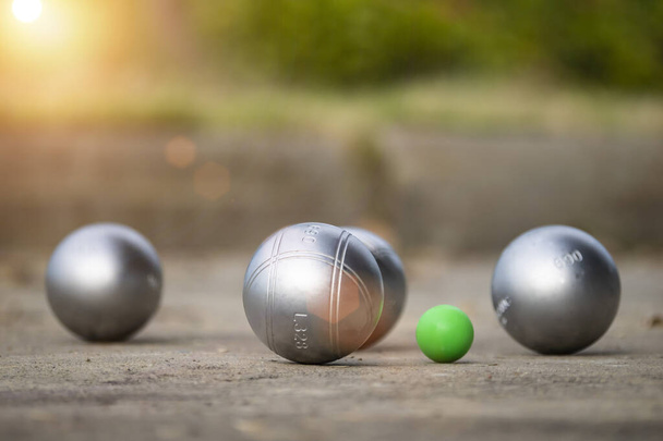 Petanque balls in the playing field with shady as a backdrop. - Foto, Bild