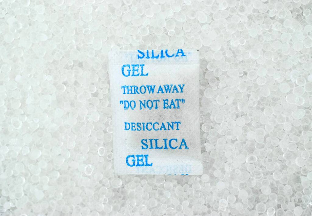 Sachet of new silica gel crystals. It is a desiccant. It adsorbs and holds water vapor. - Photo, Image