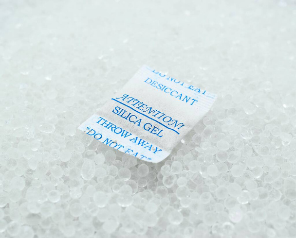 Sachet of new silica gel crystals. It is a desiccant. It adsorbs and holds water vapor. - Photo, Image