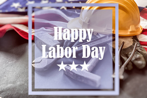Happy Labor Day text, USA flag and construction tools. United States America holiday celebration - Photo, Image